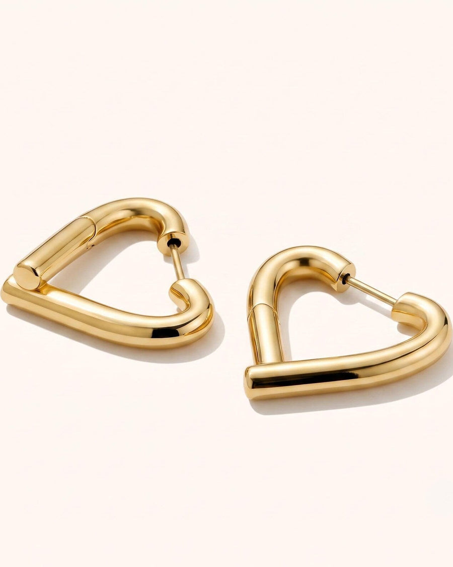 Detail Image - 14K gold heart hoop earrings with an open silhouette and clasp closure on a light background