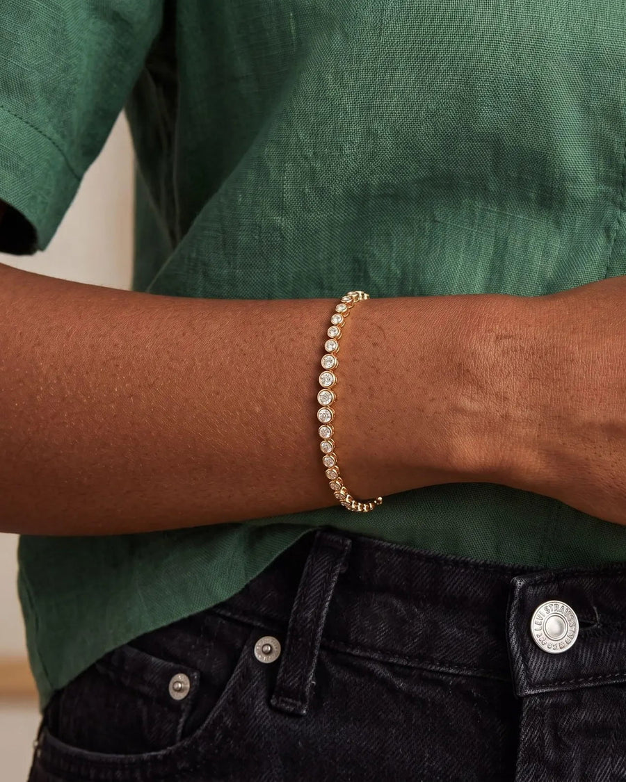 Model Image -  14k gold adjustable bezel tennis bracelet with sparkling stones worn on the wrist