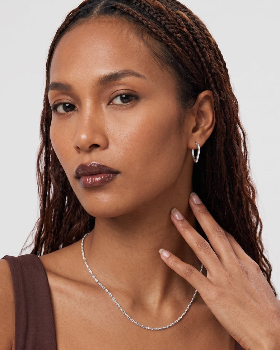 Model Image - Twist chain necklace with a delicate curved drape at the collarbone worn on model