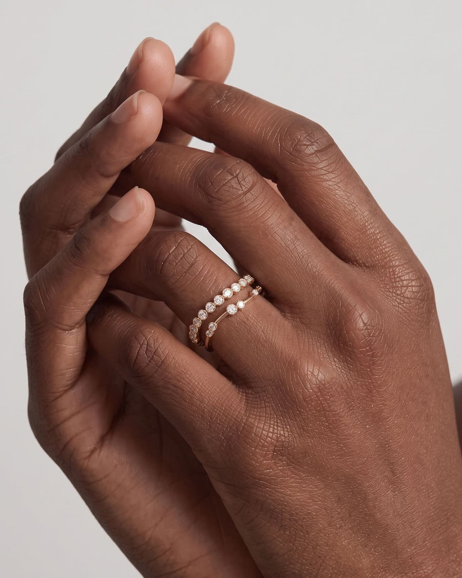 Model Image - 14k solid gold bezel lab-grown diamond wrap ring with delicately spaced round stones worn on model