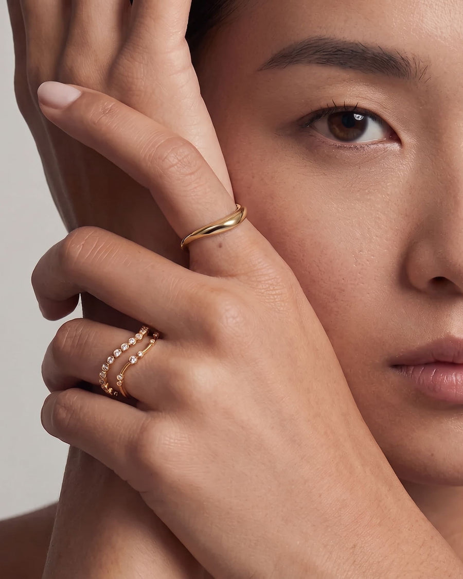 Style Image - 14k solid gold modern bezel lab-grown diamond wrap ring worn stacked on the hand for a refined layered look