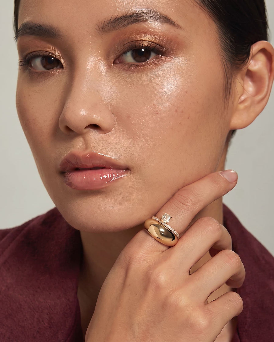 Model Image - 14k solid gold sculpted dome ring with a smooth high-polish silhouette styled on the finger worn on model