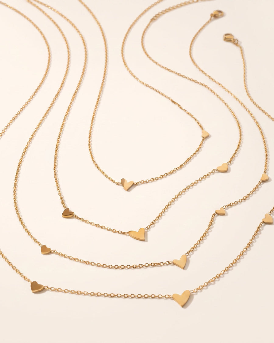 Style Image - 14K gold multi heart necklaces with dainty heart charms arranged on delicate chains