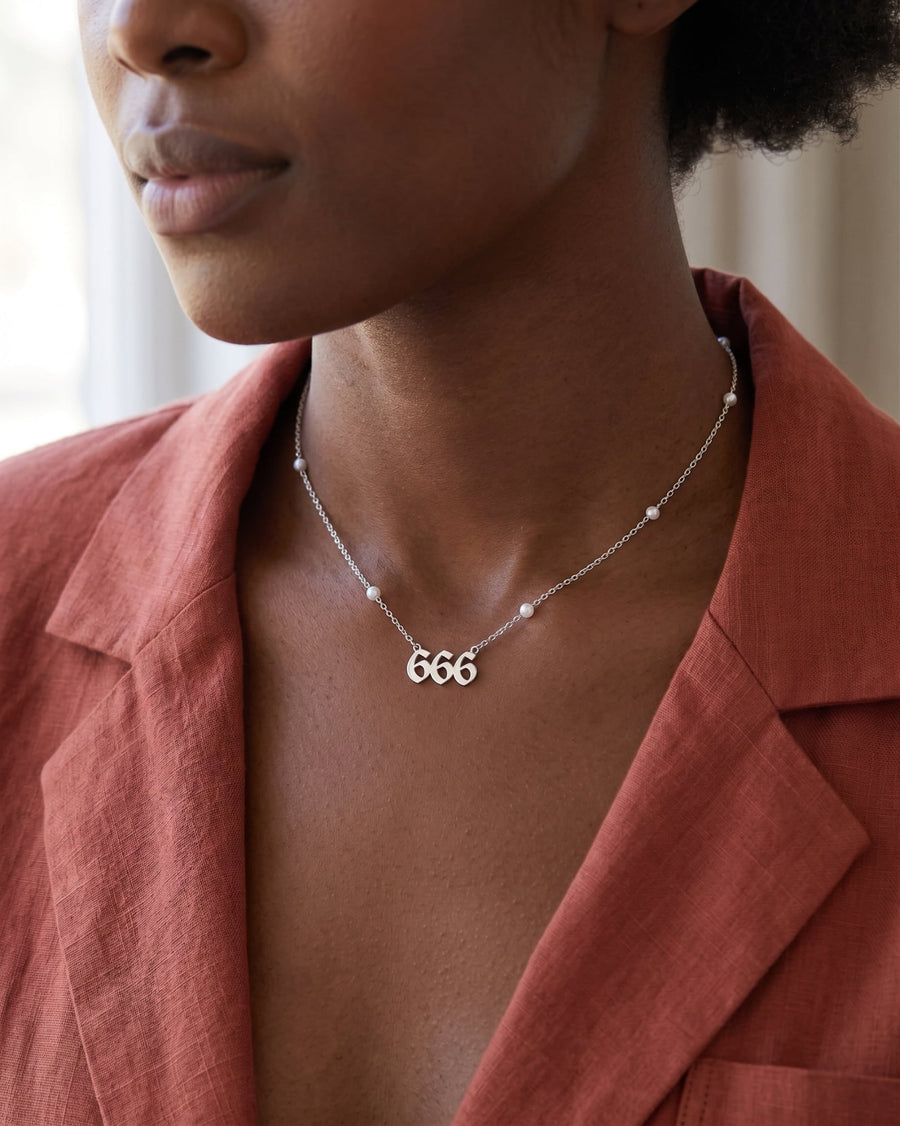 Style Image - Rhodium angel number 666 necklace with pearl bead chain detail worn at the neckline