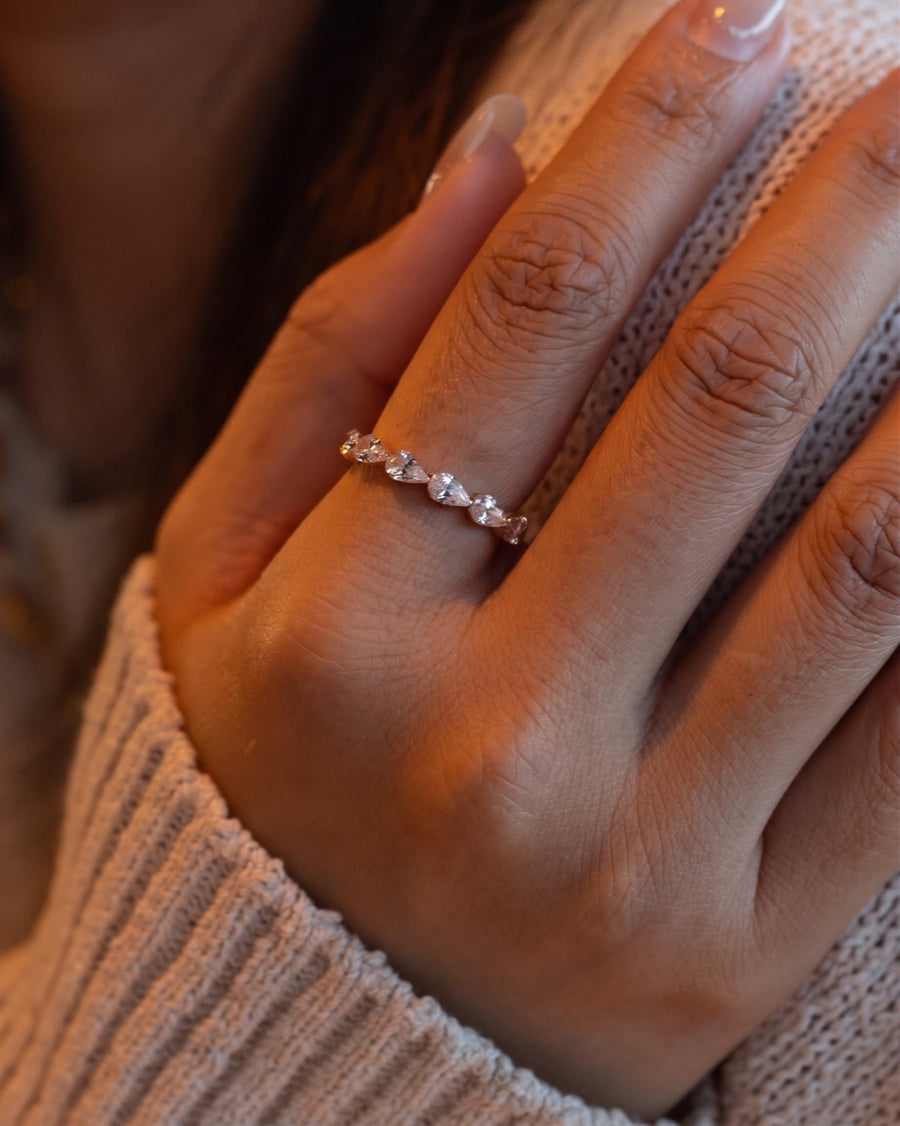 Style Image - Pear lab-grown diamond eternity ring worn on the hand with a delicate stackable band silhouette