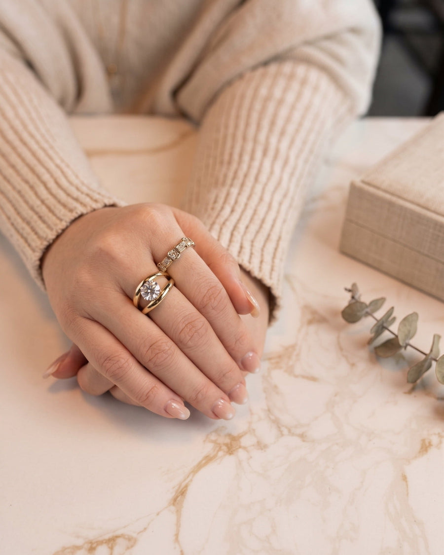 Style Image - Oval lab-grown diamond double-band ring worn on a hand against a marble surface with soft neutral styling.