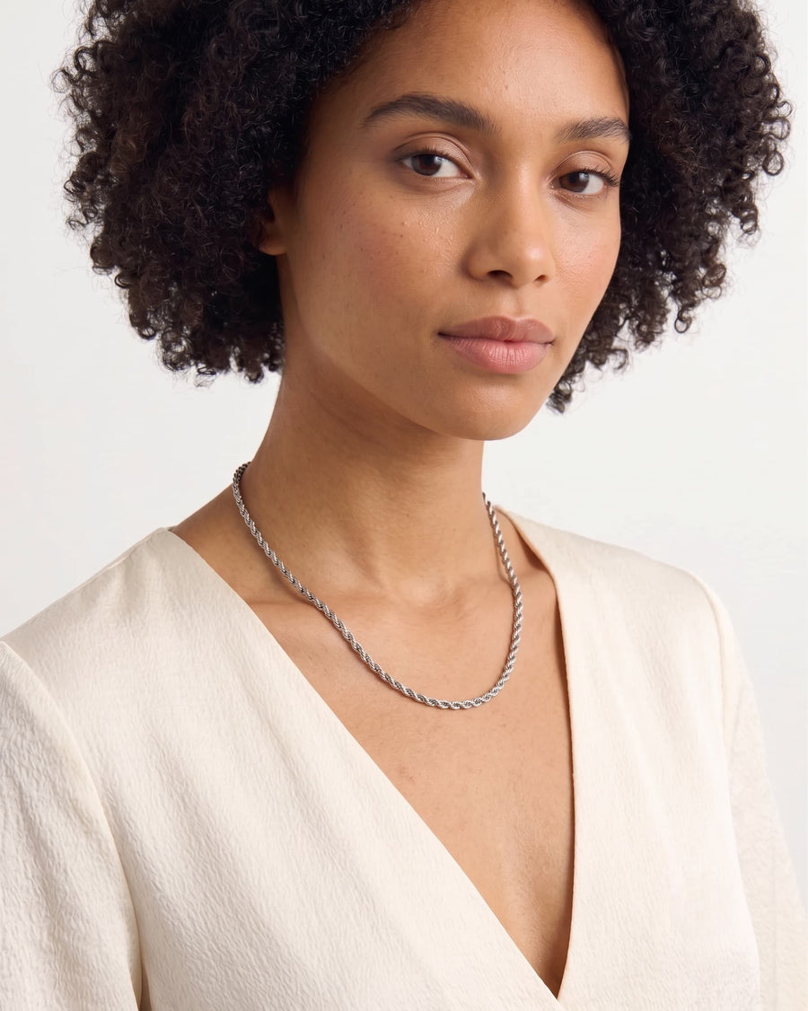 Model Image - 3mm silver rope chain necklace with a classic twisted profile styled at the neckline worn on model