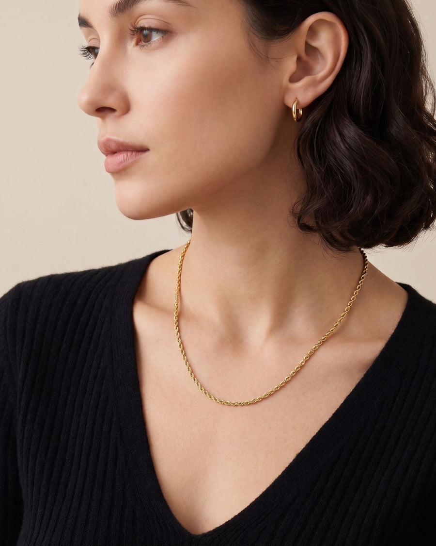 Model Image - 2mm 18k gold rope chain necklace with a textured silhouette styled along the neckline worn on model